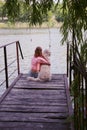 Young attractive girl with her pet dog at a beach Royalty Free Stock Photo