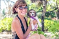 Young attractive girl with her pet dog Beagle at the beach of tropical island Bali, Indonesia. Happy moments. Royalty Free Stock Photo