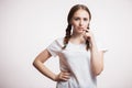 Young attractive blond girl holding myself for long braids. Portrait of beautiful smiling woman with beauty hair. A wide braid. Is Royalty Free Stock Photo