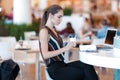 Young attractive girl iwith glass of coffee in cafe Royalty Free Stock Photo