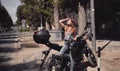 Young attractive girl with the motorbike in a break Royalty Free Stock Photo