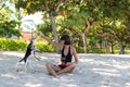 Young attractive girl playing with her pet dog Beagle at the beach of tropical island Bali, Indonesia. Happy moments. Royalty Free Stock Photo