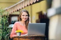 Young attractive girl sitting alone in coffee shop Royalty Free Stock Photo