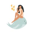 Young attractive girl sitting on a whale