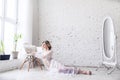 Young attractive girl in underwear and negligee in white room near window. Morning of bride. Royalty Free Stock Photo