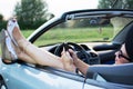 Young attractive girl using mobile phone in her car