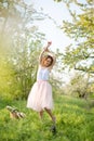 Young attractive girl walks in spring green park enjoying flowering nature Royalty Free Stock Photo