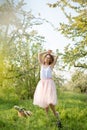 Young attractive girl walks in spring green park enjoying flowering nature Royalty Free Stock Photo