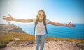 Young attractive girl in white t-shirt and jeans against the blu Royalty Free Stock Photo