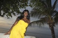 Attractive and glamorous African American black woman in chic and elegant summer dress posing relaxed