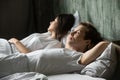 Young attractive couple sleeping in bed at home Royalty Free Stock Photo