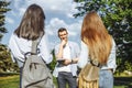 Young attractive guy making a choice between two girls. Love triangle Royalty Free Stock Photo