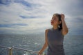 Young attractive and happy Asian Chinese woman on excursion ship or ferry enjoying sea breeze on summer holiday sea boat trip Royalty Free Stock Photo