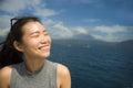 Attractive and happy Asian Chinese woman on excursion ship or ferry looking ocean and island enjoying sea breeze on summer holiday Royalty Free Stock Photo
