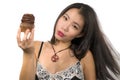 Young attractive and happy Asian Korean woman holding delicious and tempting chocolate cupcake full of calories having dilemma