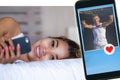 Young attractive and happy Asian woman lying on bed using social media app in mobile phone searching man for online dating sending Royalty Free Stock Photo