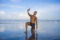 Young attractive and happy black afro American sport man with athletic body and sixpack taking selfie photo with mobile phone at