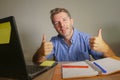 Young attractive and happy business man working at home office smiling confident and positive in successful work concept giving th Royalty Free Stock Photo