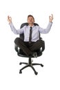 Young attractive happy businessman relaxing with hands in yoga position sitting on office chair Royalty Free Stock Photo