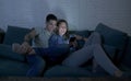 Young attractive and happy couple using internet app on mobile phone enjoying and laughing together sitting at home living room so Royalty Free Stock Photo