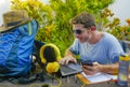 Young attractive and happy digital nomad man working outdoors with laptop computer cheerful and confident running business remote Royalty Free Stock Photo