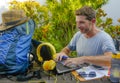 Young attractive and happy digital nomad man working outdoors with laptop computer cheerful and confident running business remote Royalty Free Stock Photo