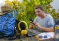 Young attractive and happy digital nomad man working outdoors with laptop computer cheerful and confident running business remote Royalty Free Stock Photo