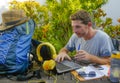 Young attractive and happy digital nomad man working outdoors with laptop computer cheerful and confident running business remote Royalty Free Stock Photo