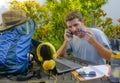 Young attractive and happy digital nomad man working outdoors with laptop computer cheerful and confident running business remote Royalty Free Stock Photo