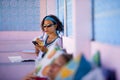 Young attractive and happy hipster Asian woman working with laptop computer and mobile phone at relaxing outdoors workplace enjoyi Royalty Free Stock Photo