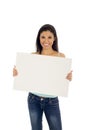 Young attractive and happy hispanic woman holding blank billboard with copy space Royalty Free Stock Photo