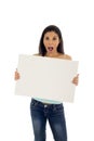 Young attractive and happy hispanic woman holding blank billboard with copy space Royalty Free Stock Photo