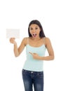 Young attractive and happy hispanic woman holding blank card with copy space Royalty Free Stock Photo