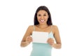 Young attractive and happy hispanic woman holding blank card with copy space Royalty Free Stock Photo