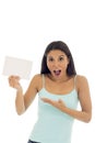 Young attractive and happy hispanic woman holding blank card with copy space Royalty Free Stock Photo