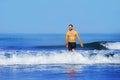 Young attractive and happy man with beard and swimming trunks at tropical paradise desert beach alone playful and cheerful in sea