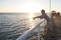 Young attractive and happy man in shirt and hat fishing at beach sea dock using fish road enjoying weekend hobby in holidays Royalty Free Stock Photo