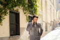 Young attractive happy man talking on smart phone in european city