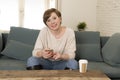 Young attractive and happy red hair woman sitting at home sofa c Royalty Free Stock Photo