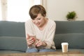 Young attractive and happy red hair woman sitting at home sofa c Royalty Free Stock Photo