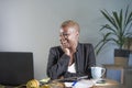 Young attractive and happy successful black afro american woman in business jacket working cheerful at office laptop computer desk Royalty Free Stock Photo