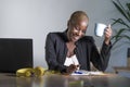 Young attractive and happy successful black afro american woman in business jacket working cheerful at office laptop taking notes