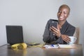 Young attractive and happy successful black afro american woman in business jacket working cheerful at office laptop using mobile Royalty Free Stock Photo