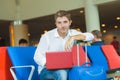 Young attractive and relaxed traveler man with luggage working with laptop computer waiting for flight at airport departure lounge Royalty Free Stock Photo