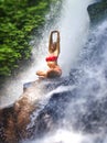 Young attractive and happy woman with fit body practicing yoga wet under tropical paradise waterfall stream screaming excited with Royalty Free Stock Photo