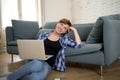 young attractive and happy woman at home sofa relaxed and dreamful using computer laptop shopping on line smiling excited Royalty Free Stock Photo