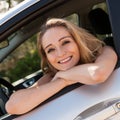 Young attractive happy woman sitting in car summertime Royalty Free Stock Photo