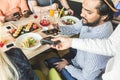 Young attractive Hindu man paying in cafe with contactless smartphone payment Royalty Free Stock Photo