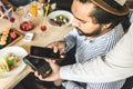 Young attractive Hindu man paying in cafe with contactless smartphone payment Royalty Free Stock Photo