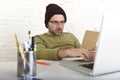 Young attractive hipster businessman working from his home office as freelancer self employed business model Royalty Free Stock Photo